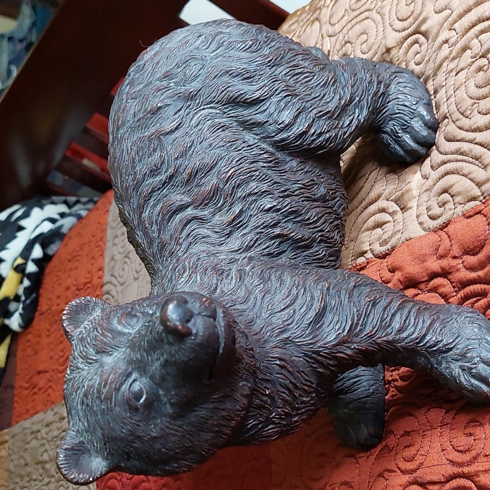 Solid resin signed bear. Length  is 15 inches x 8 1/2